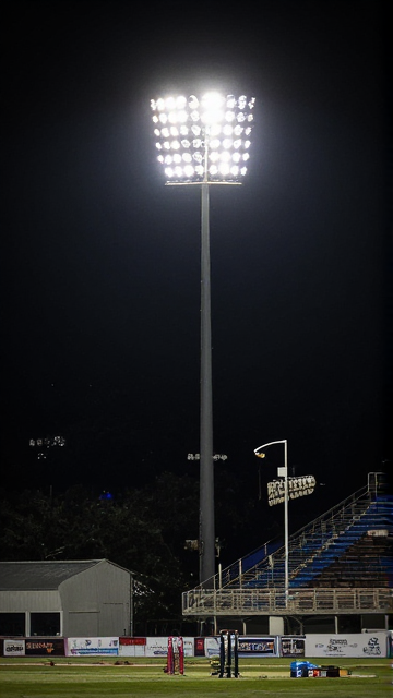 Tall floodlight tower illuminating a stadium