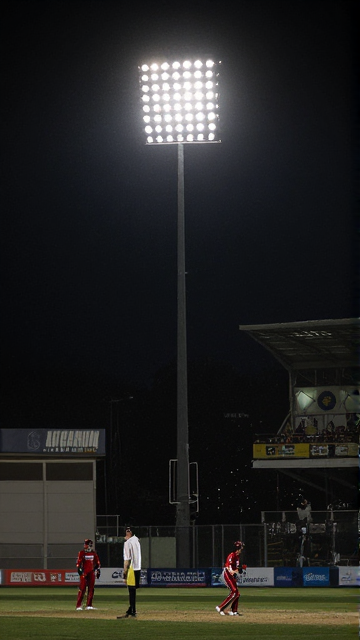 Floodlight mast lighting a cricket ground at night